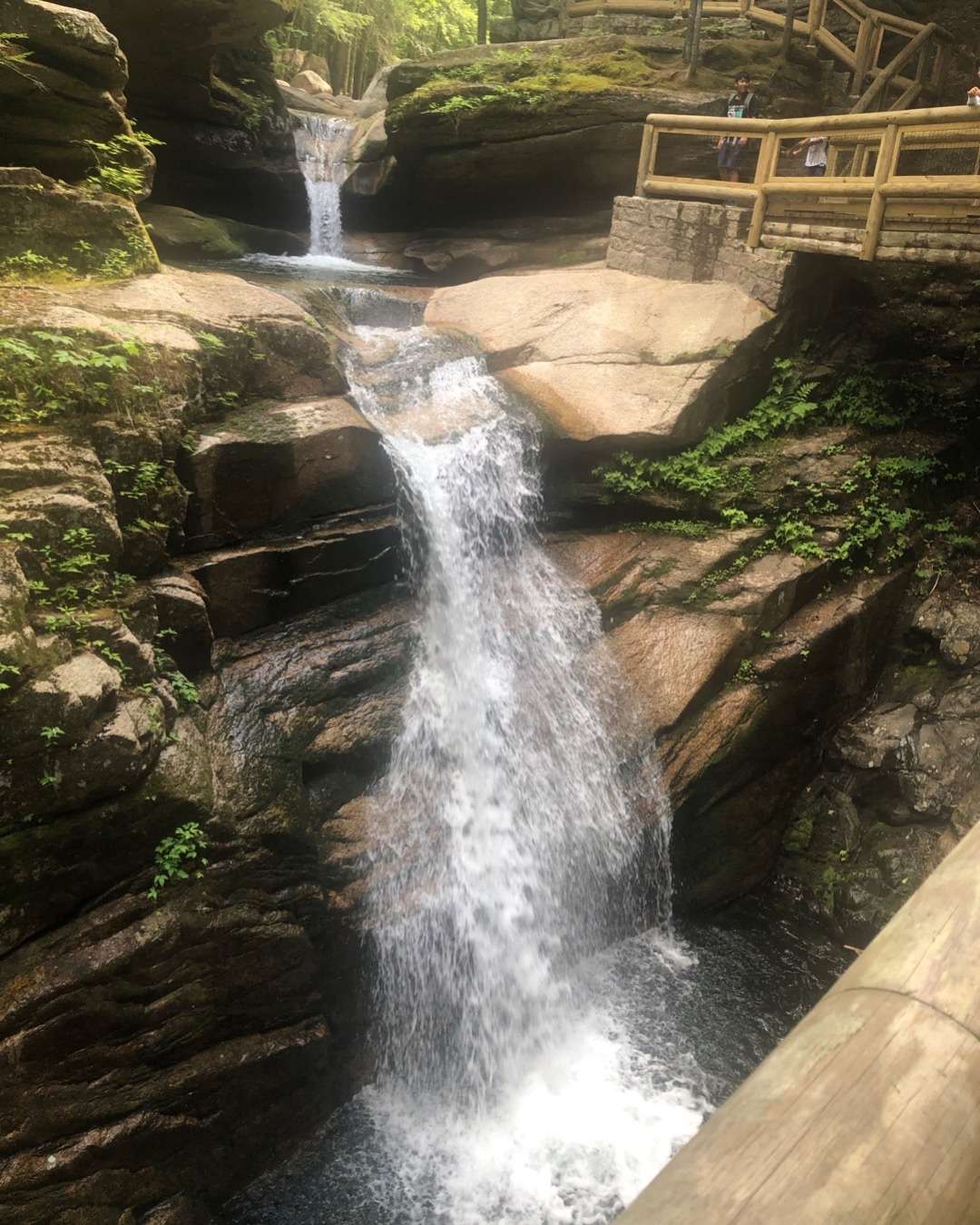 Pretty waterfall with bridge next to it